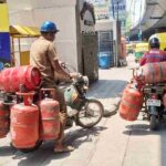 LPG Cylinder with Gas Delivery Boy Symbolic Image