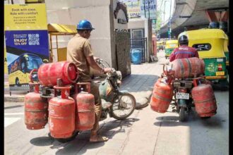 LPG Cylinder with Gas Delivery Boy Symbolic Image